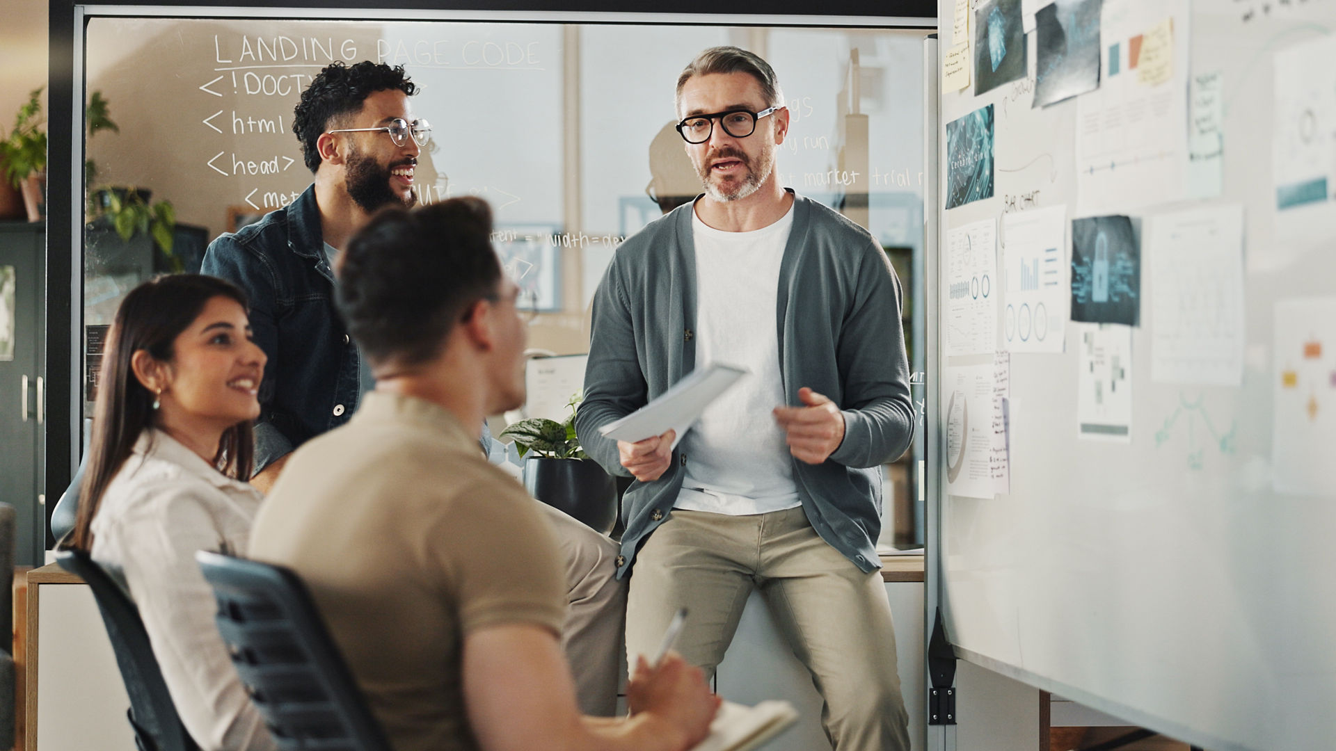 Meeting, web development and whiteboard with business people in office for feedback or review. Data, graphs and statistics with creative employee group in workplace for planning, strategy or vision.