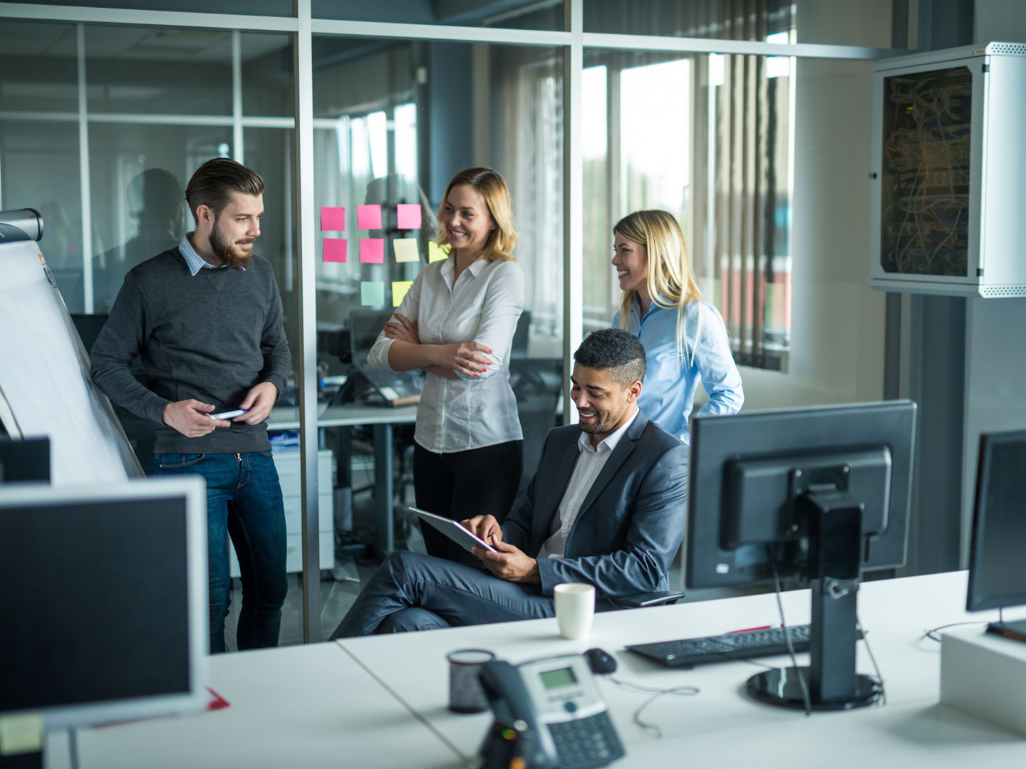 Happy team of coworkers working together in an office.