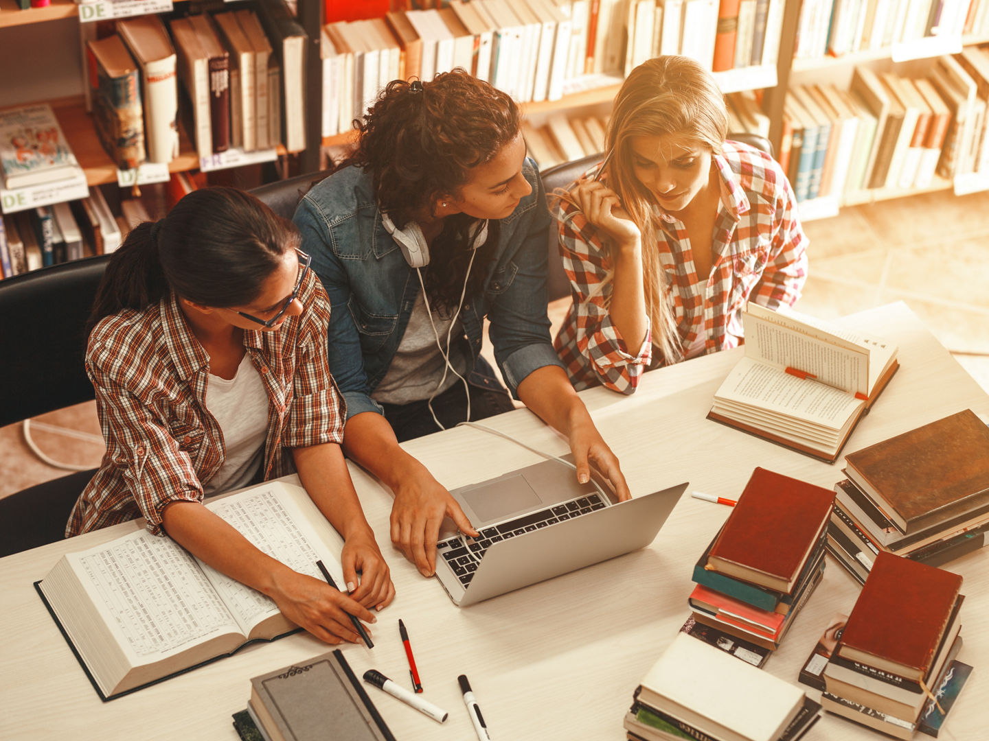 Group of female students study in the school library.Learning and preparing for university exam.