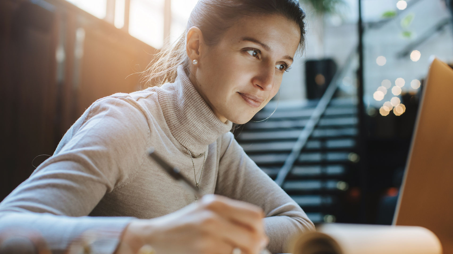 Attractive woman reading good news from business partners on laptop