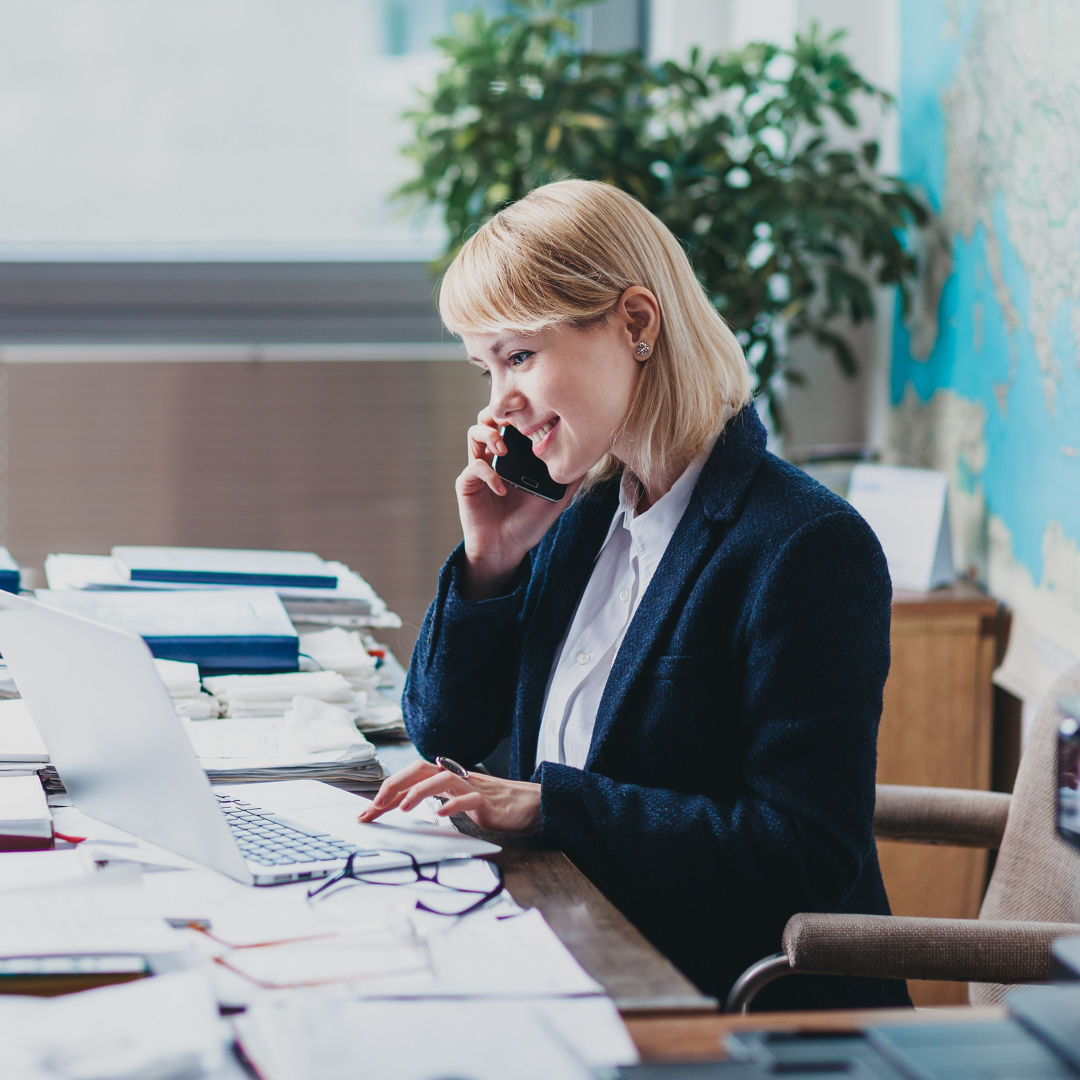 Young woman at the office talking on cellphone