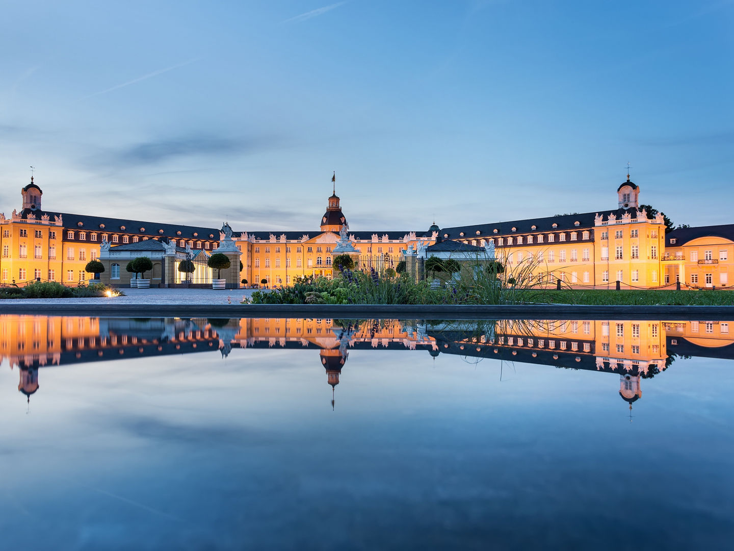 Karlsruhe castle reflected in water in summer evening