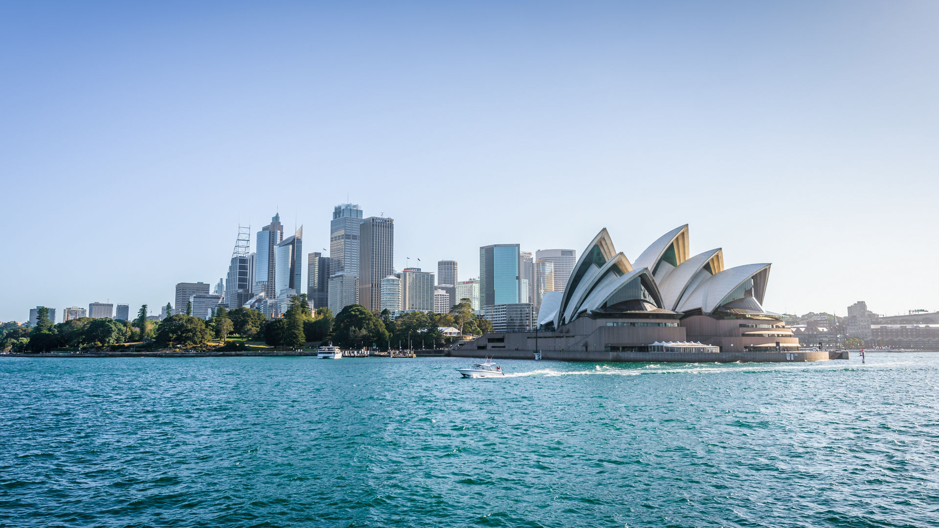  Beautiful sunny coast view to the Skyline and famous Opera House on bright warm day, cruising by ferry from harbour quay bridge to Manly City, Opera House and Quay,Sydney, NSW/ Australia – 10 12 2017,  Beautiful sunny coast view to the Skyline and famous Opera Hous