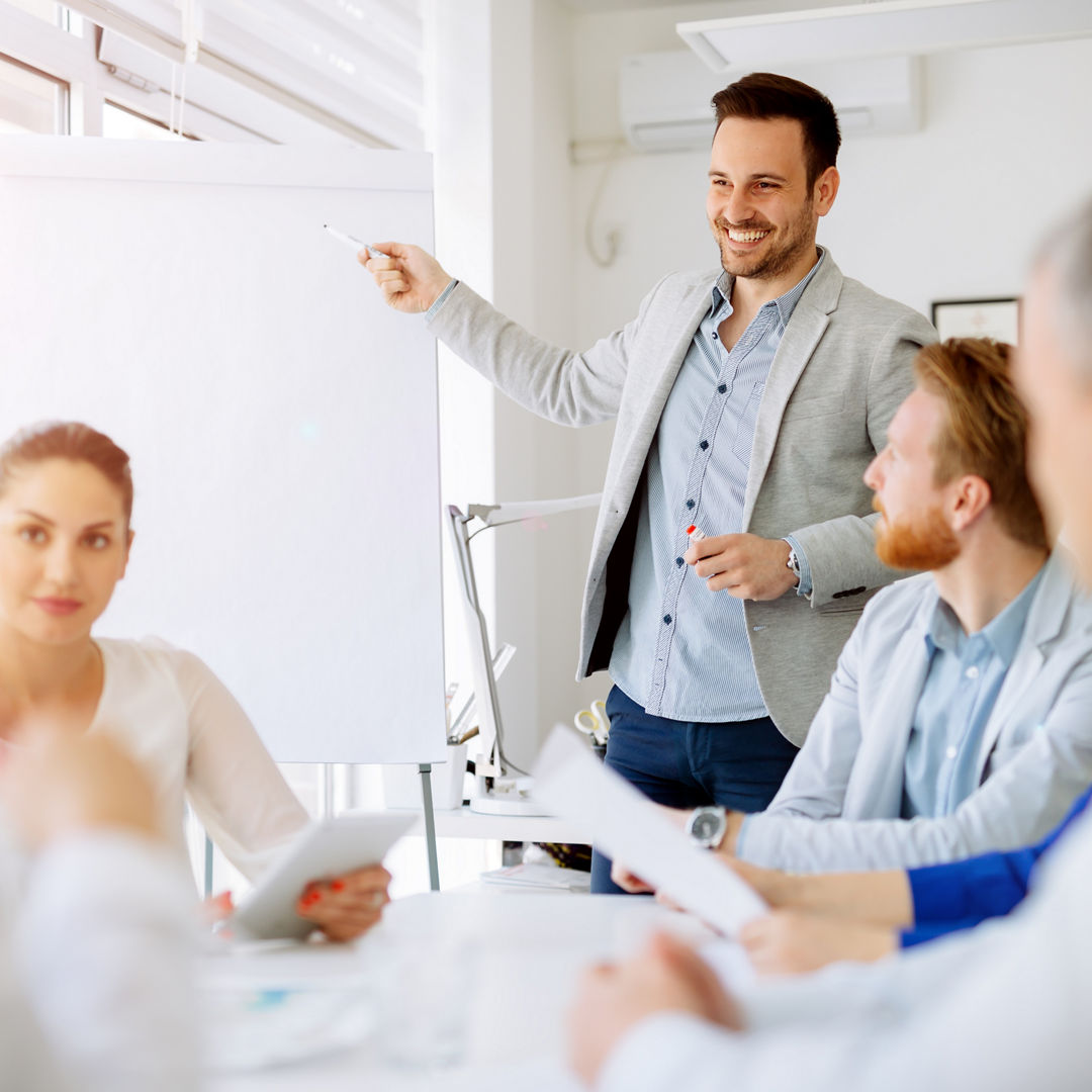 Business plan explained on flipchart by CEO to employees