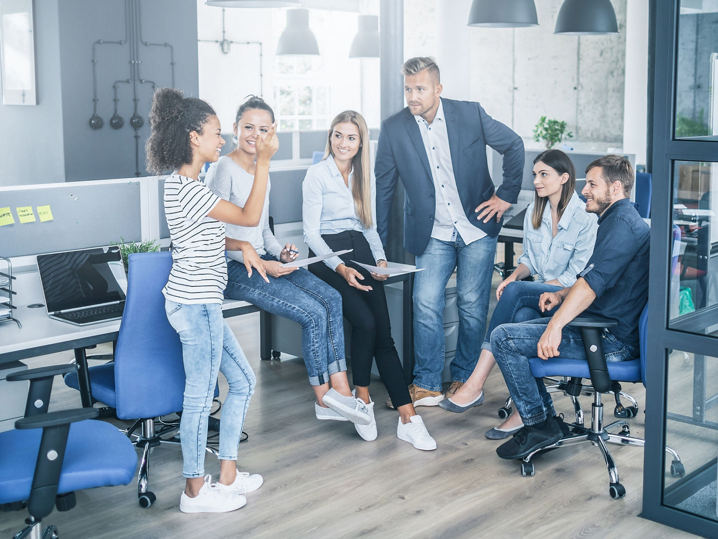 Team at work. Group of young business people working together in creative modern office.