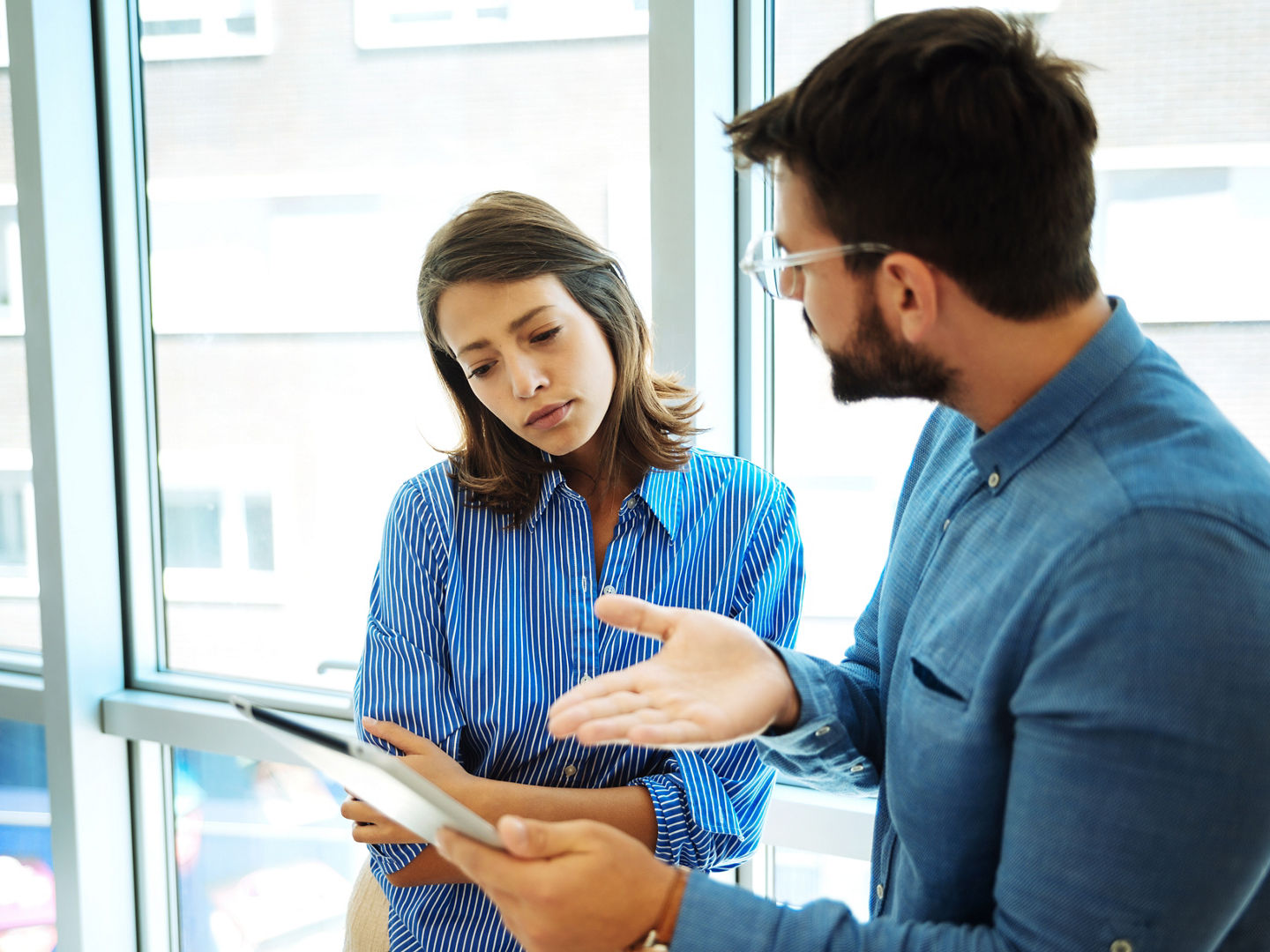 Young business couple with tablet in the office