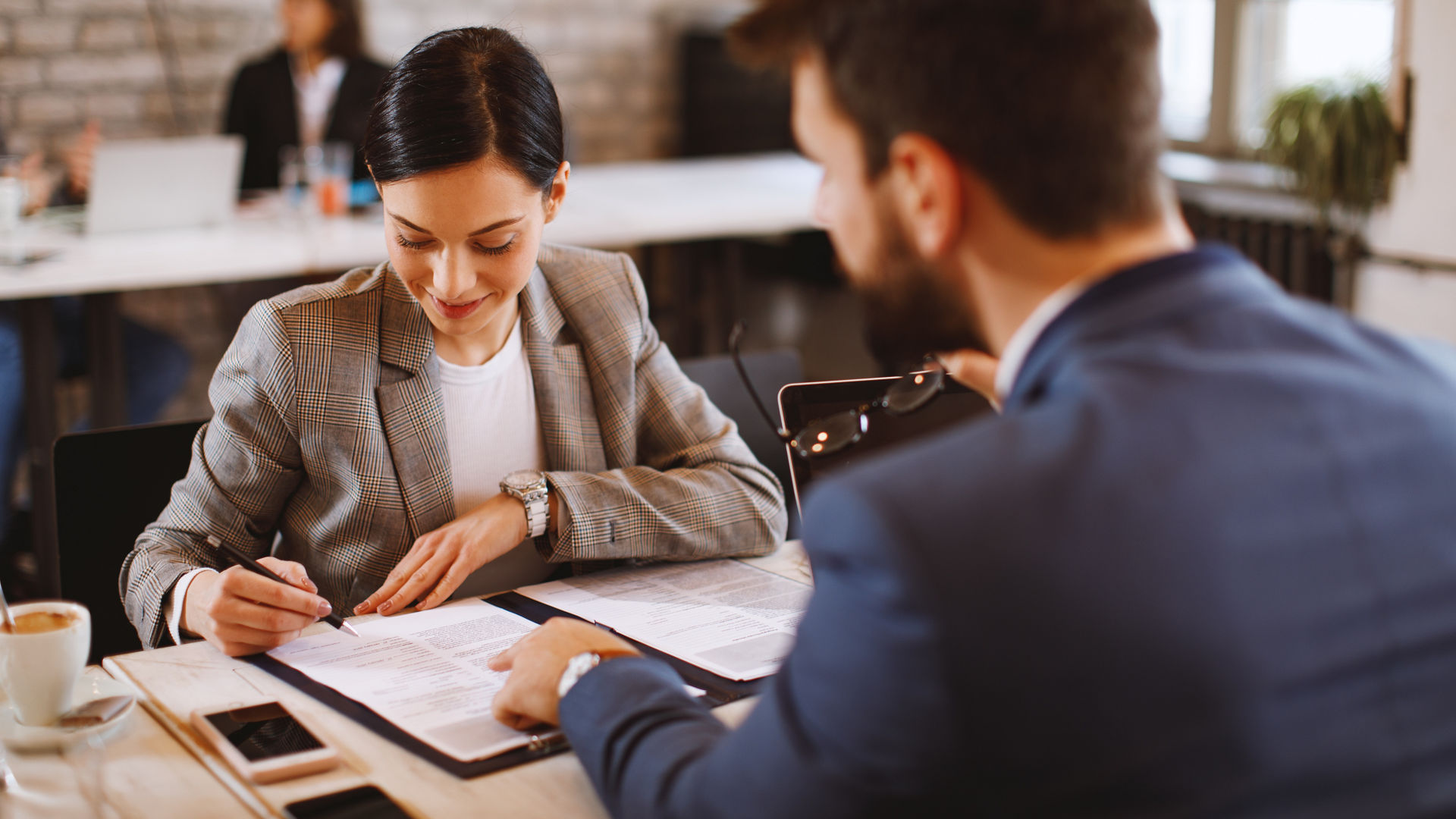 Young woman signs an employment contract