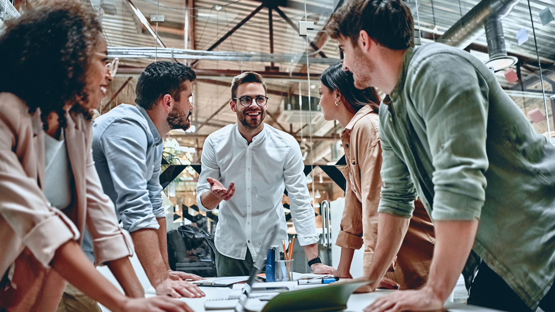 Group of young multiracial business people are working in modern office. Freelancers in coworking place. Creative and stylish youth.