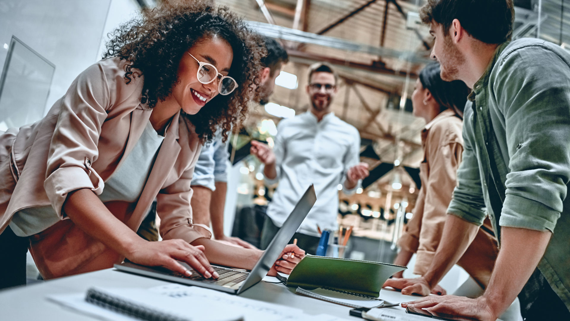 Group of young multiracial business people are working in modern office. Freelancers in coworking place. Creative and stylish youth.
