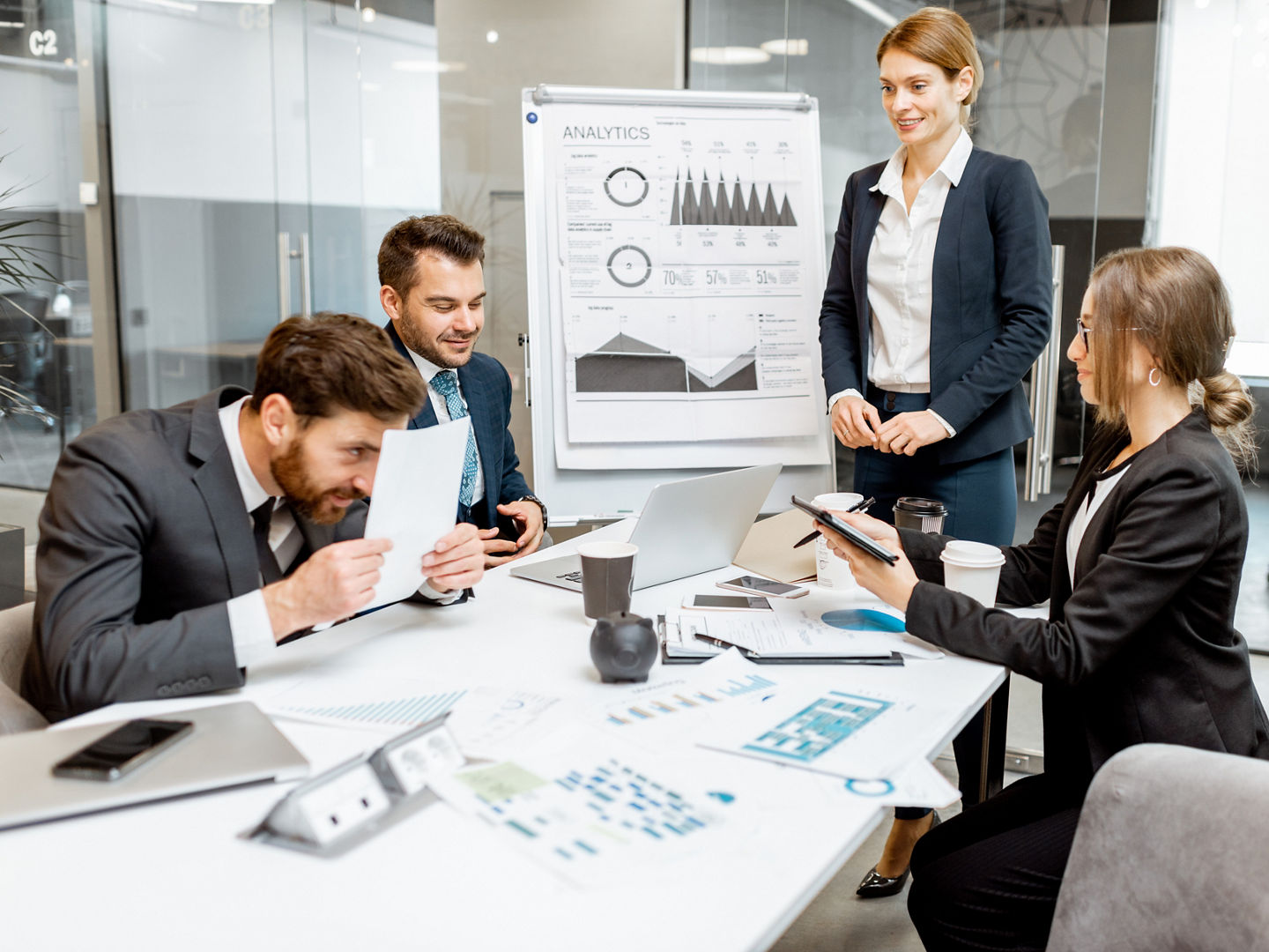 Business people discussing some financial issues, speaker giving a presentation on a small conference in the meeting room, funny employee