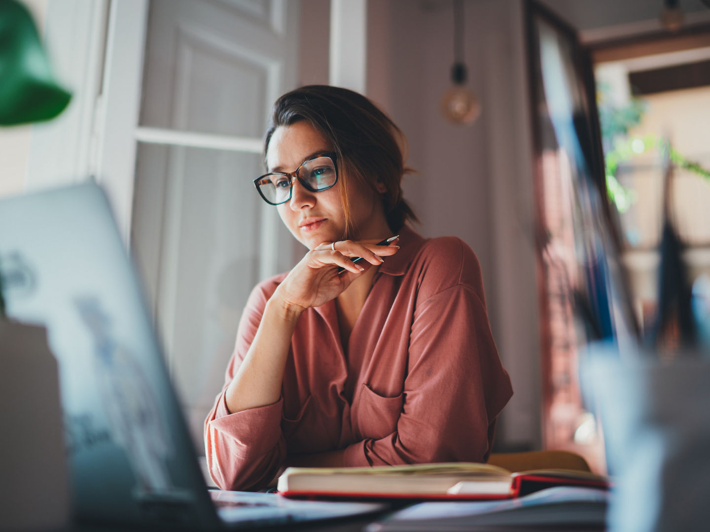 Beautiful businesswoman sitting at table opposite laptop in workplace brainstorming new project, People technology Concept, Beautiful businesswoman sitting at table opposite laptop in work