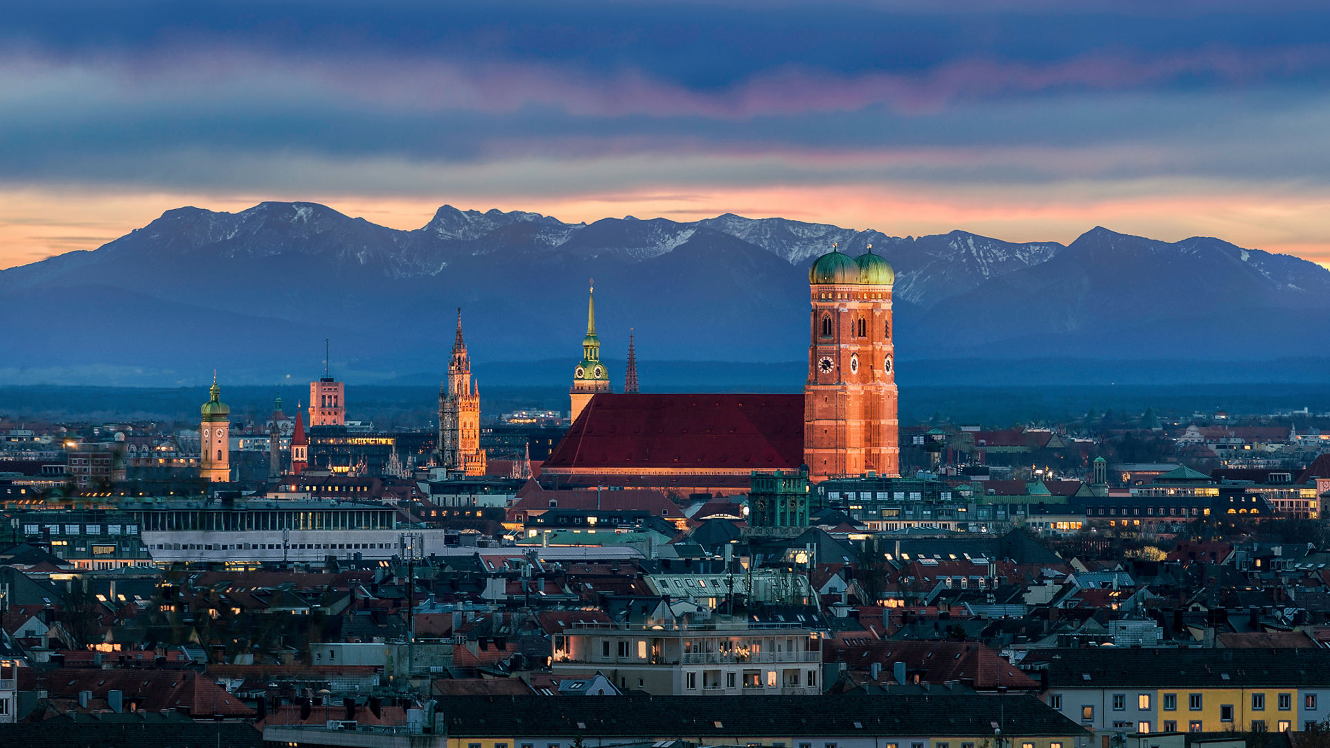 Munich at dusk - Mountains of German Alps behind Frauenkirche