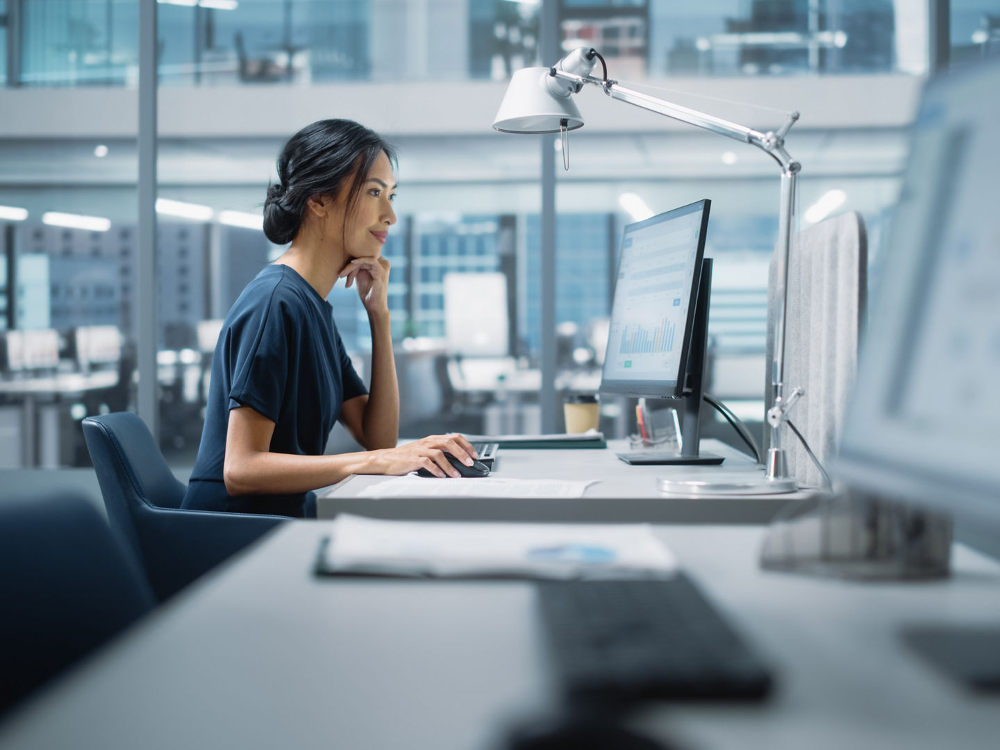 In Big Diverse Corporate Office: Portrait of Beautiful Asian Manager Using Desktop Computer, Businesswoman Managing Company Operations, Analysing Statistics, Commerce Data, Marketing Plans.