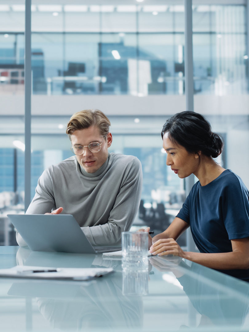 Multiethnic Diverse Office Conference Room Meeting: Team of Two Creative Entrepreneurs Talk, Discuss Growth Strategy. Stylish Young Businesspeople work on Investment and Marketing Projects.