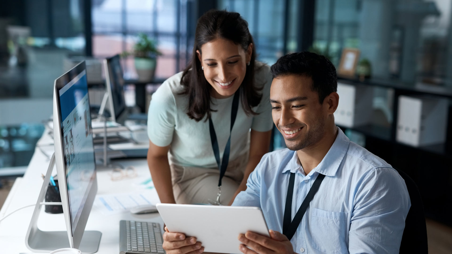 Shot of a young businessman and businesswoman using a digital tablet in a modern office.