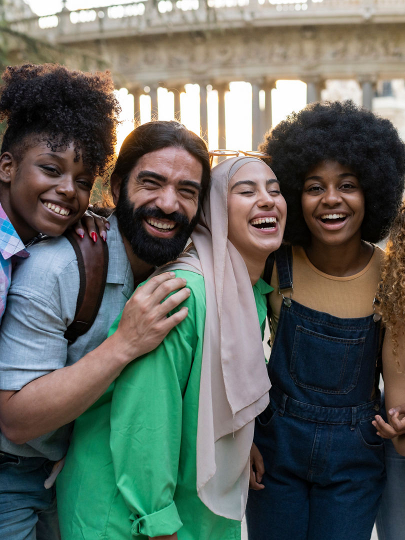 group of young multiracial friends traveling in the city