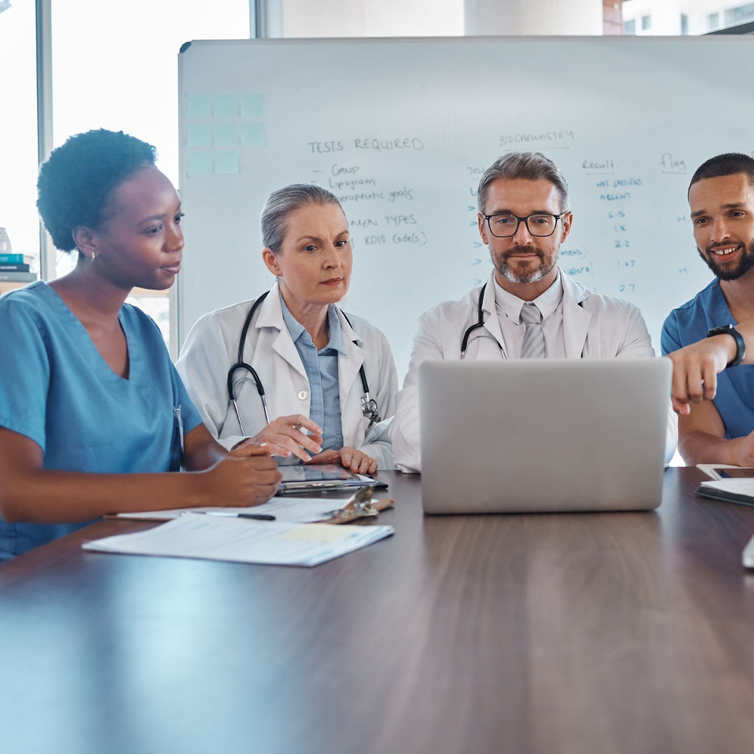 Hospital teamwork, laptop and healthcare planning, medical analytics and wellness collaboration of doctors, nurse and surgeon in meeting. Diversity, training or clinic workers consulting online tech.