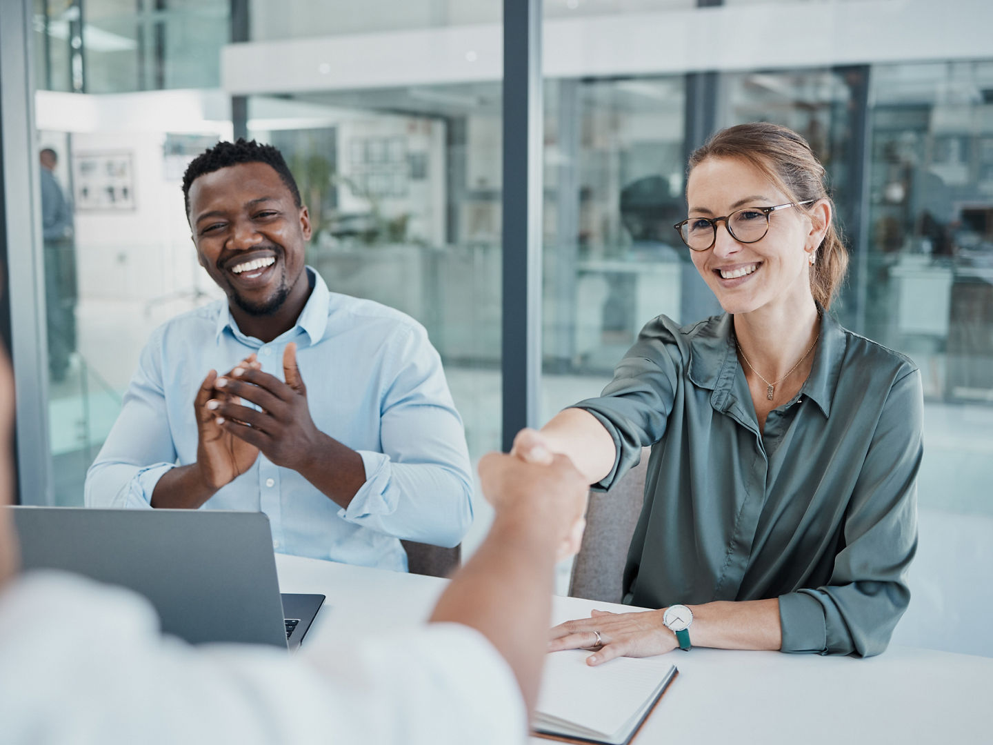 Business people, handshake and interview in celebration for recruitment, hiring and employment at the office. Happy corporate executives congratulating new employee shaking hands for company growth.