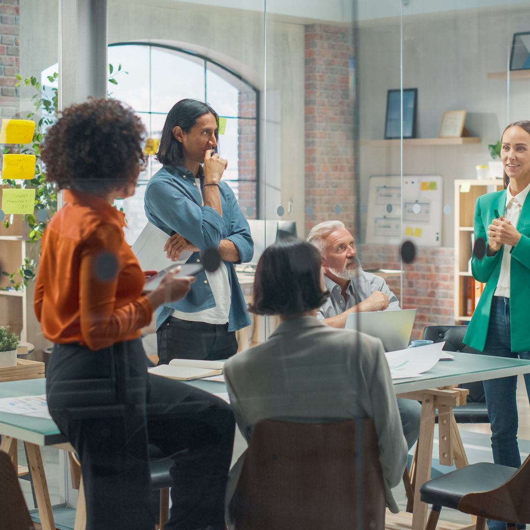 Female Business Coach for Company Management Explains How to Train your Team Efficiently in a Workshop Inside Creative Office. Woman Trainer Writing on Whiteboard and Training Interactive Employees, Female Business Coach for Company Management Explains How to Tra