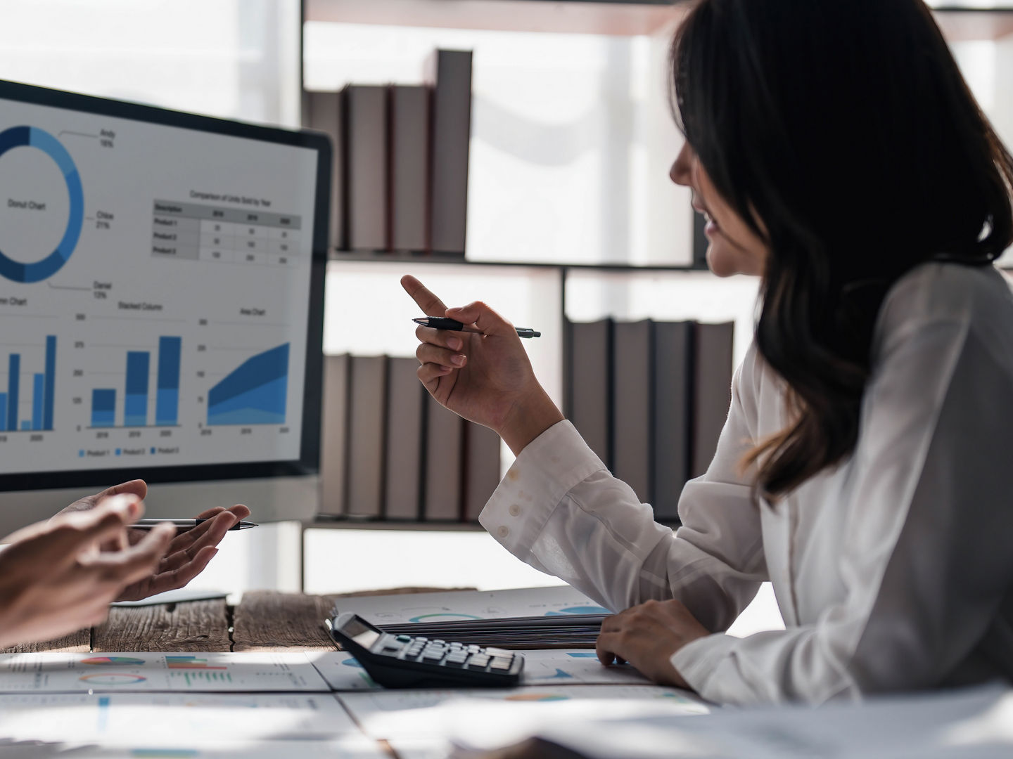 Two business people talk project strategy at office meeting room. Businessman discuss project planning with colleague at modern workplace while having conversation and advice on financial data report...