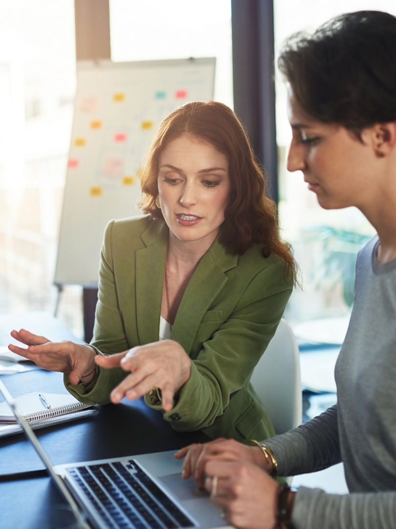 Boardroom, mentor and business people with laptop for discussion, research and access to company page. Office, web designer and manager in creative agency with digital for startup, progress or review.