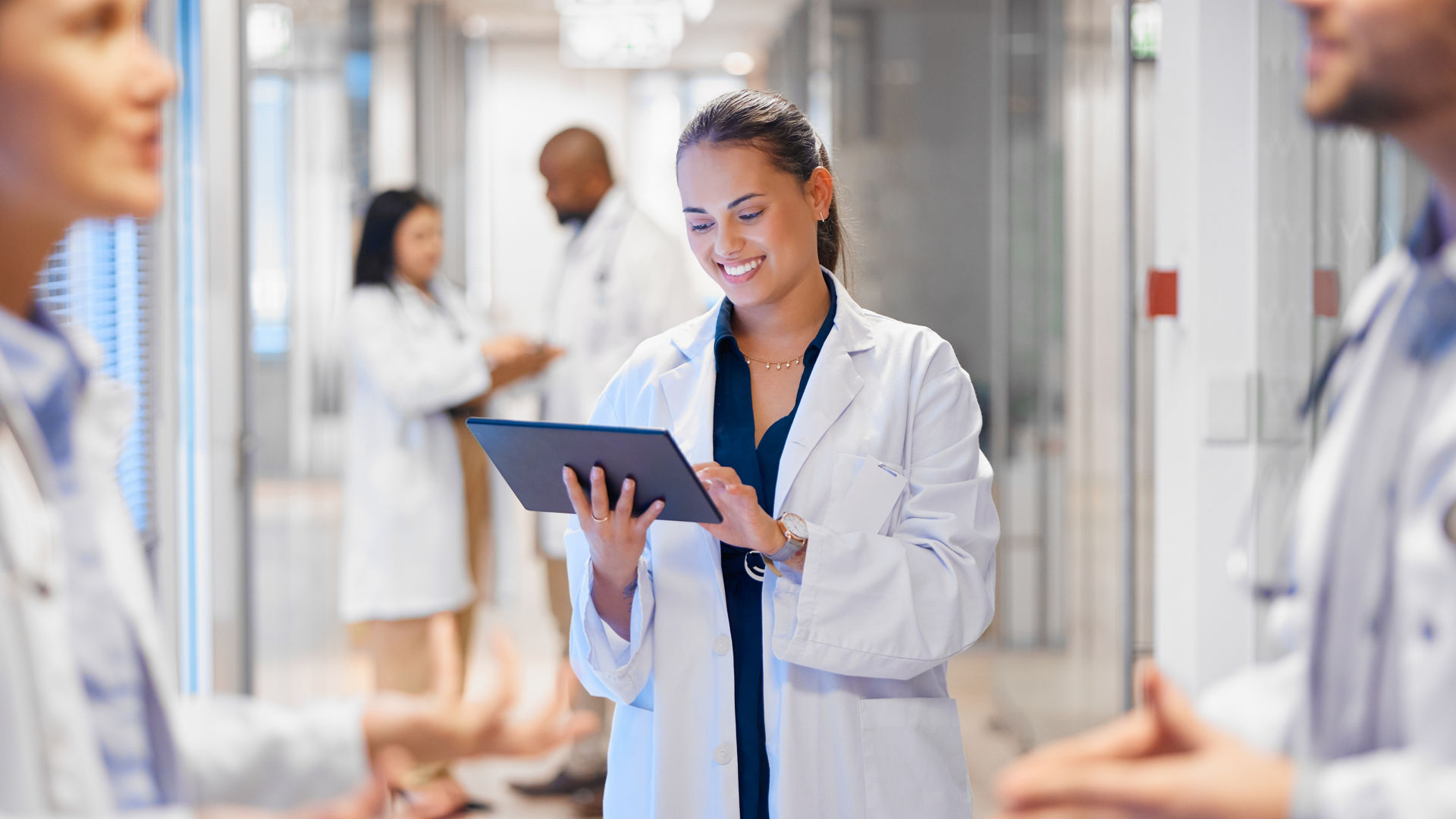 Happy woman doctor on tablet for employees management, hospital workflow and clinic staff solution on software or app. Healthcare manager on digital tech for medical team research or problem solving.