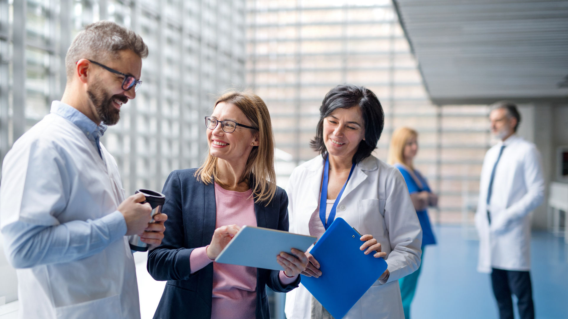 Group of doctors talking to pharmaceutical sales representative on conference.