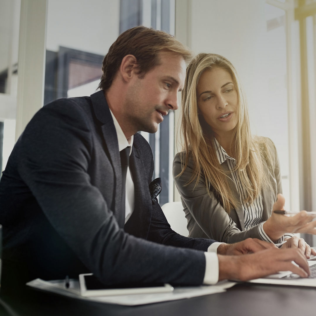 Business man, woman or partner on laptop and pointing, typing or help with question, talking or workplace. Businessman, female manager and computer for corporate training, teamwork or solution at job